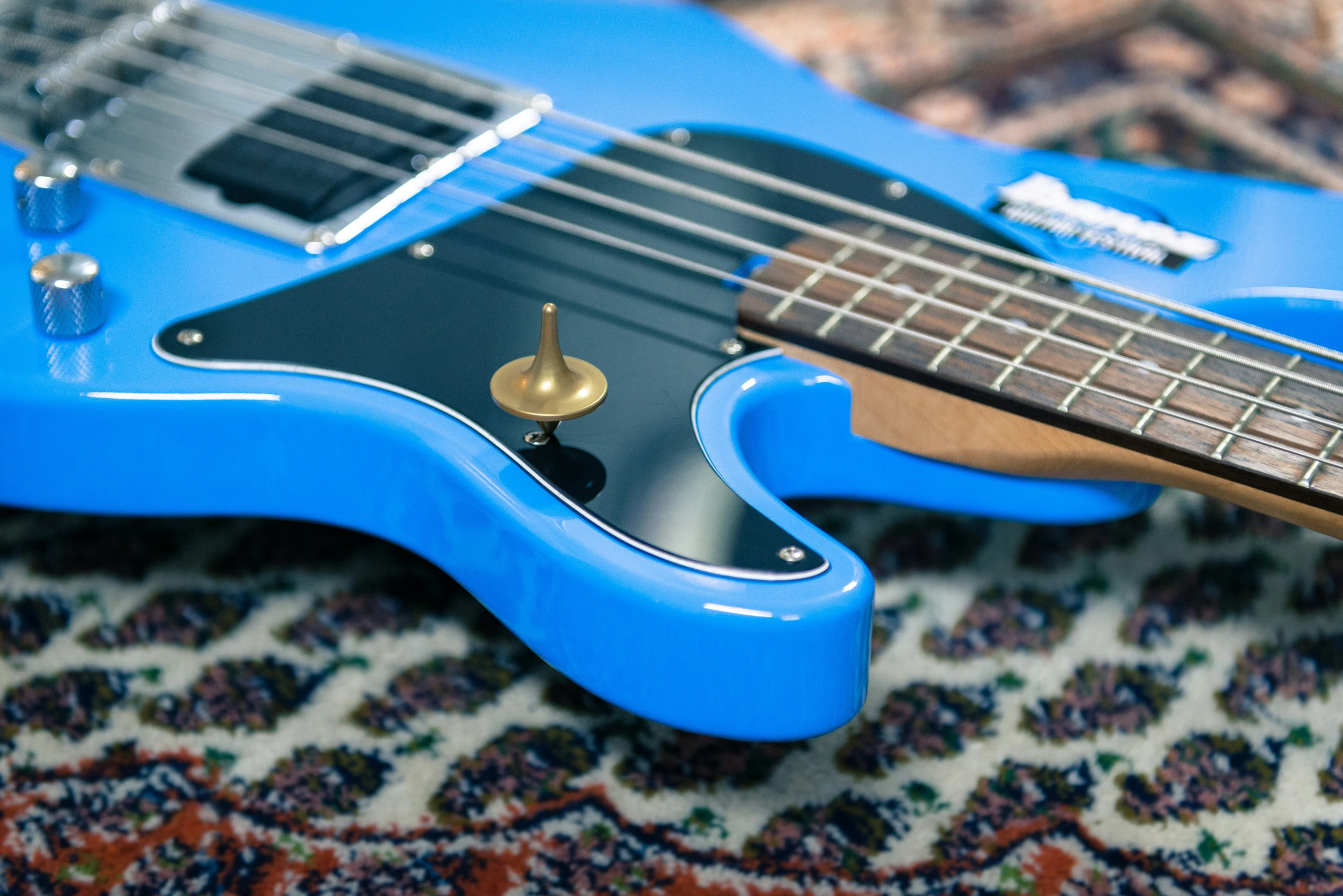 a blue electric guitar is laying on its side