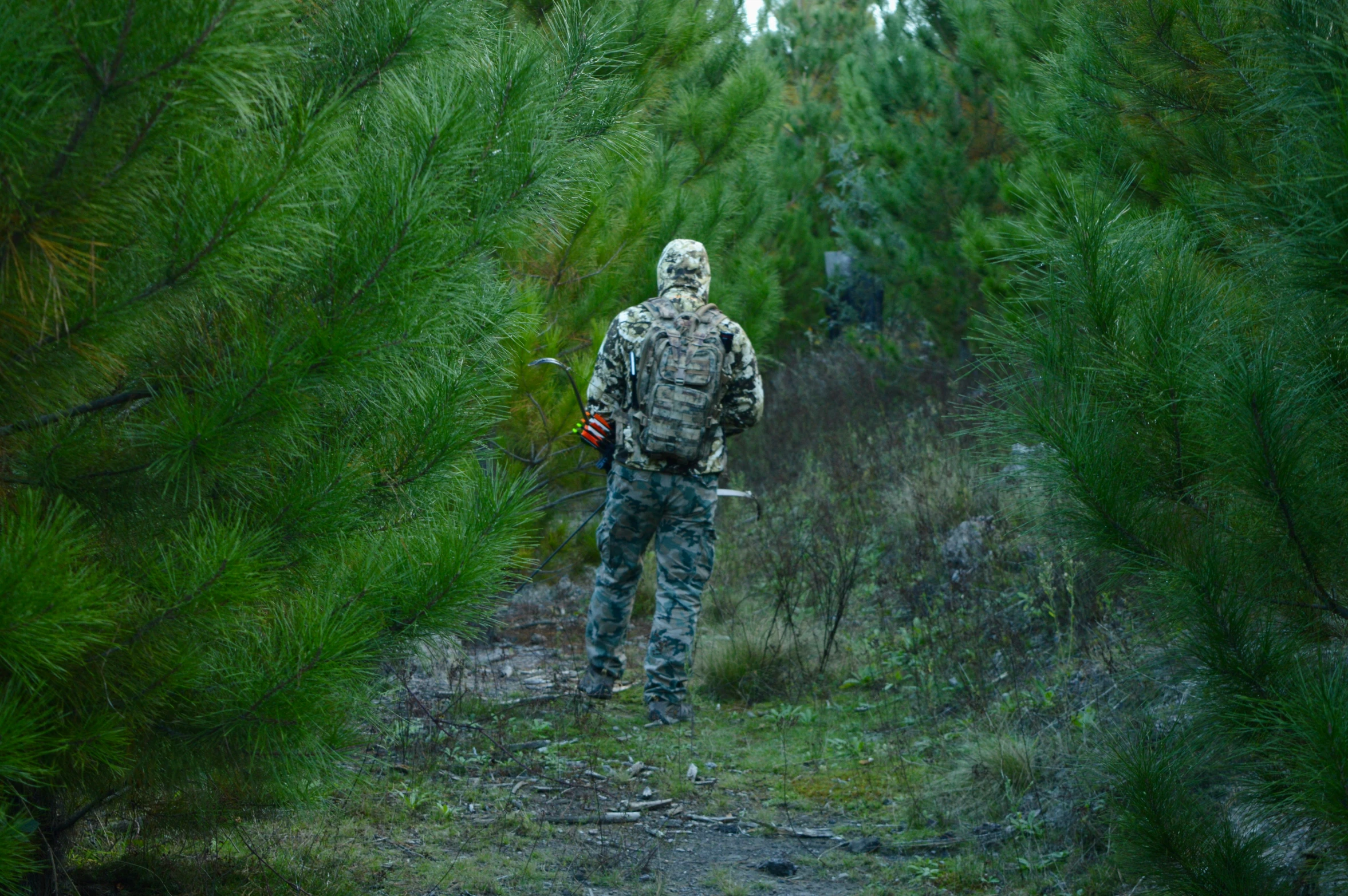 a person in camouflage with some hunting equipment