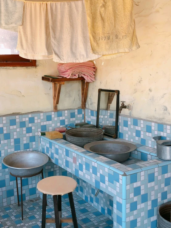 a bathroom is decorated in blue and white tiles