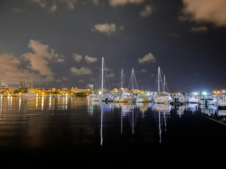 boats sitting in the water during night