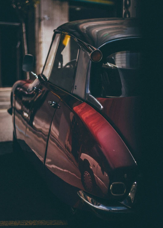 a red car parked in front of a garage