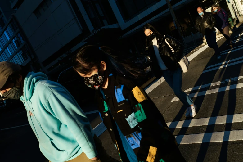 two girls are walking down a street with some masks