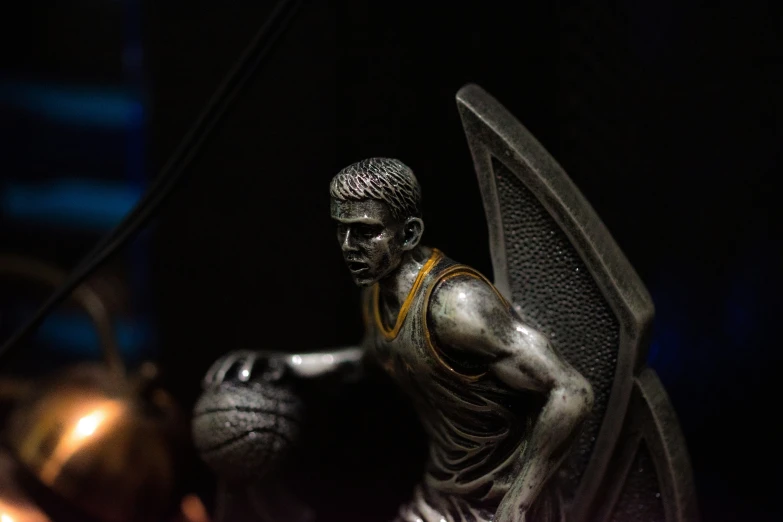 there is a statue holding two basketballs in his hands