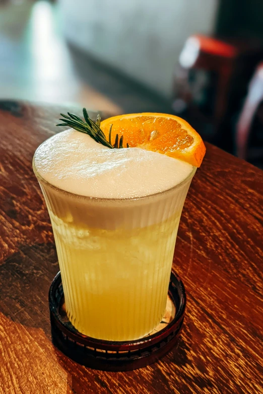 a glass of drink on a wooden table