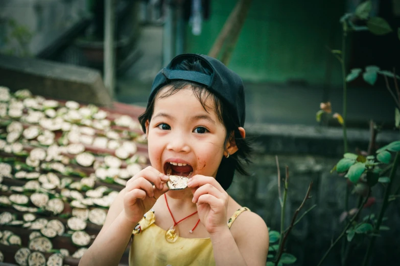 there is a small girl eating some kind of food