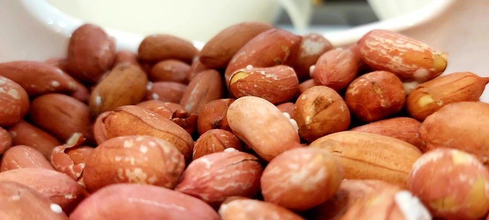 the nuts are in a white bowl on the table