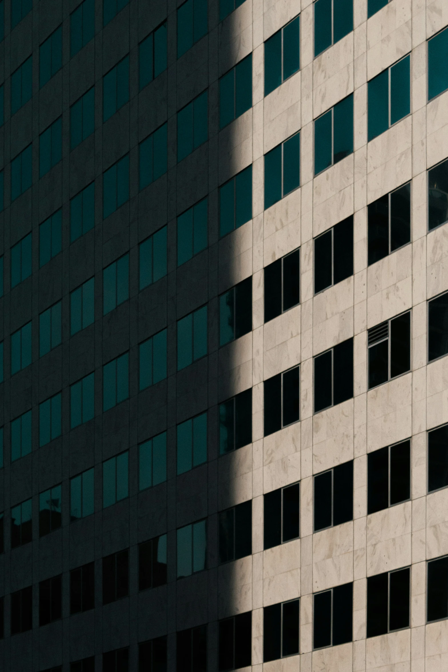 an airplane flying over the top of a tall building