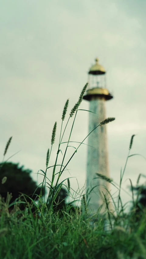 a tall light house with a small white tower