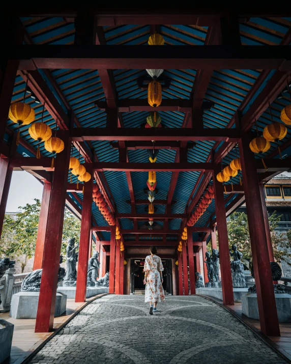 a person walking through a red pavilion