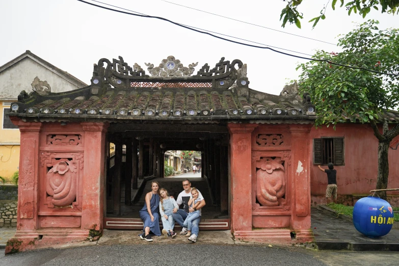 two women are sitting outside near a building