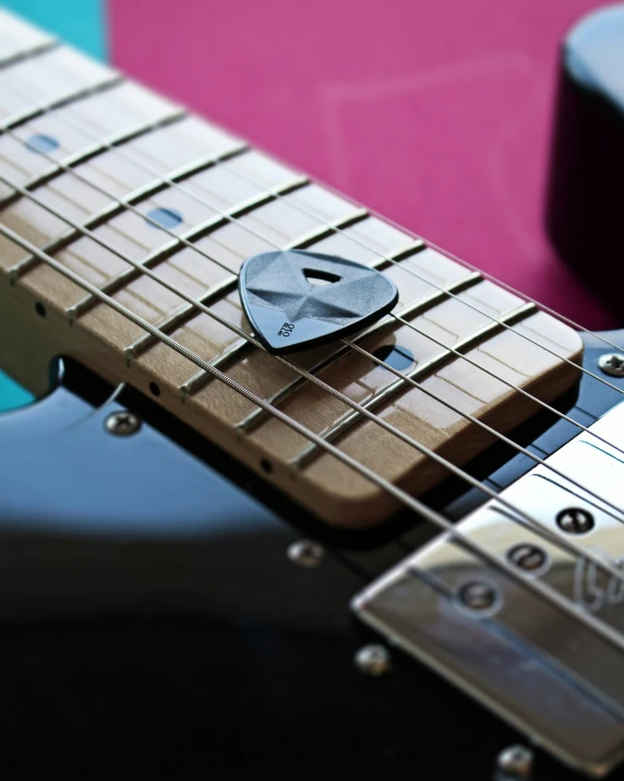 a guitar with an object embedded in it on top