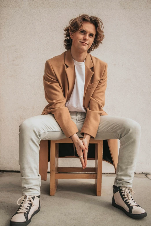 a person that is sitting on a stool