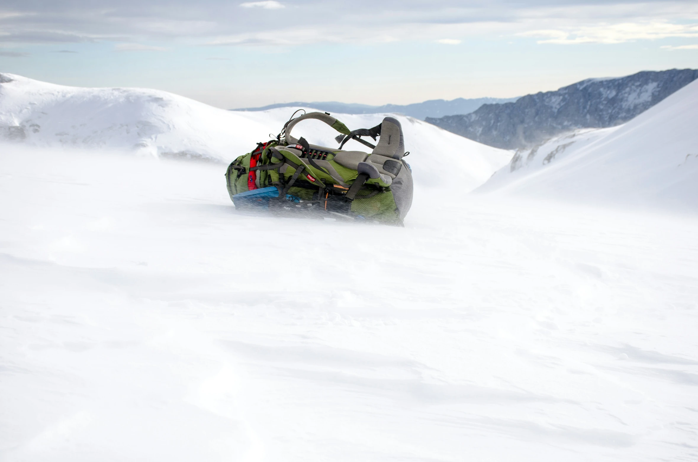 the snow board is lying on the hill top