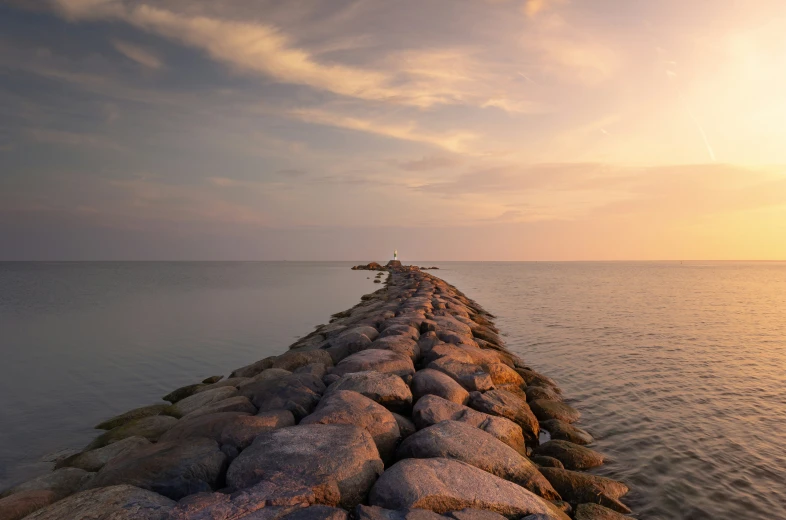 the long pier stretches out over a large body of water