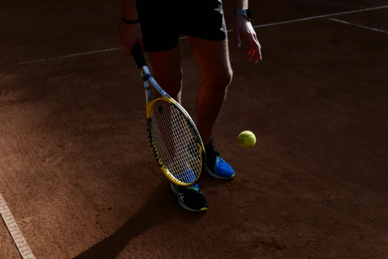 a man holding his tennis racquet as he gets ready to hit a ball