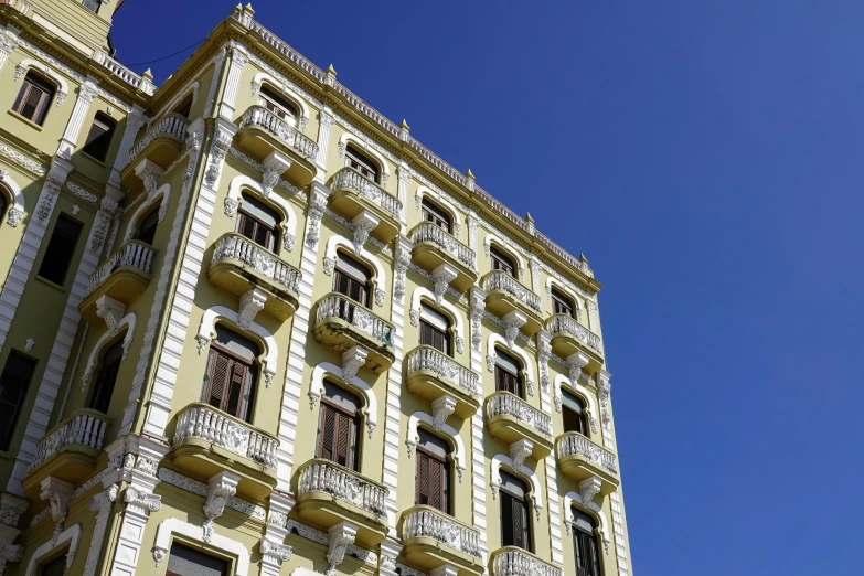 a building with balconies against the blue sky