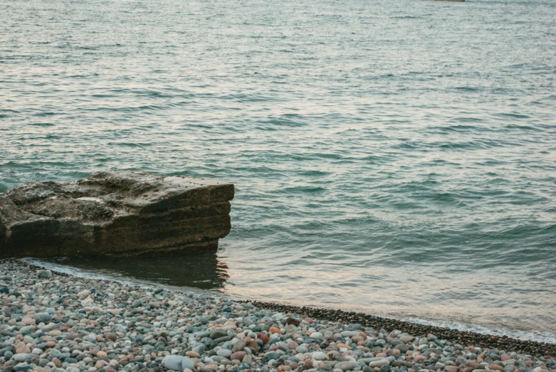 an ocean scene with the rocks on the shoreline