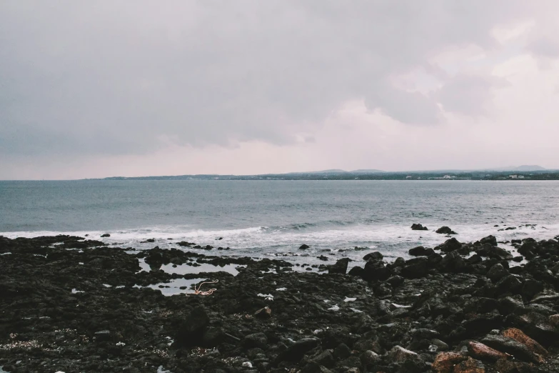 a very large body of water with waves and rocks