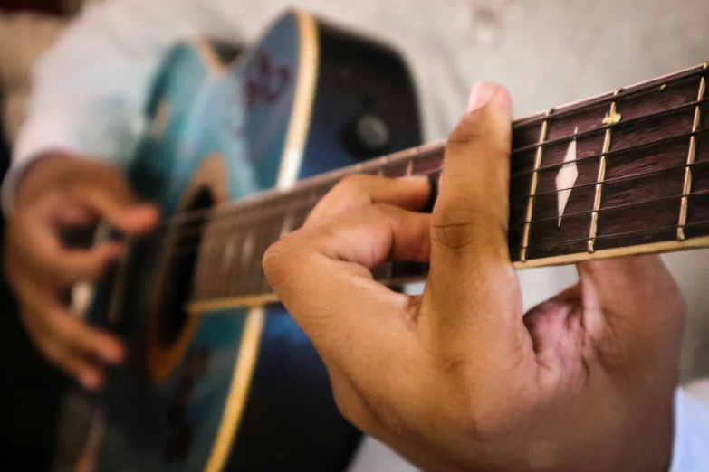 a close up of someone playing the guitar