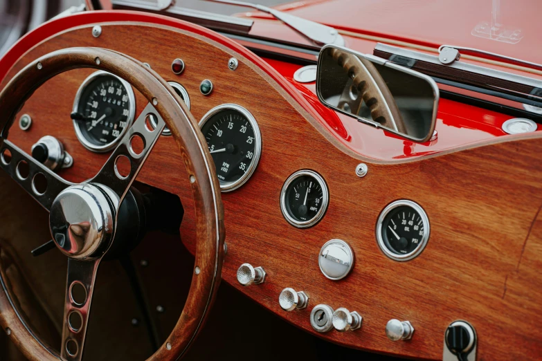 an old car dashboard with gauges and a steering wheel