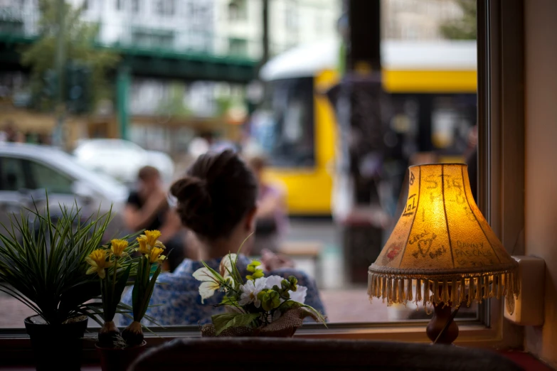 an outdoor area with tables and chairs, flowers, and lamp