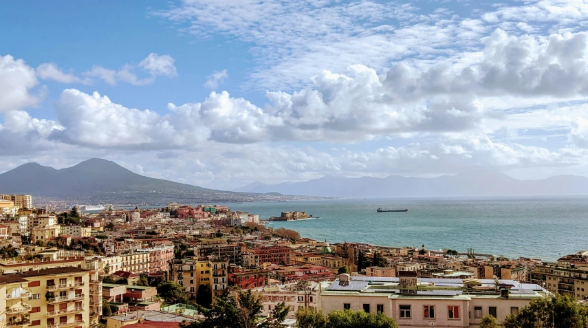 a city sits overlooking the ocean on a hill