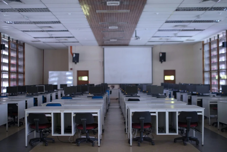 an empty room with desks and computers