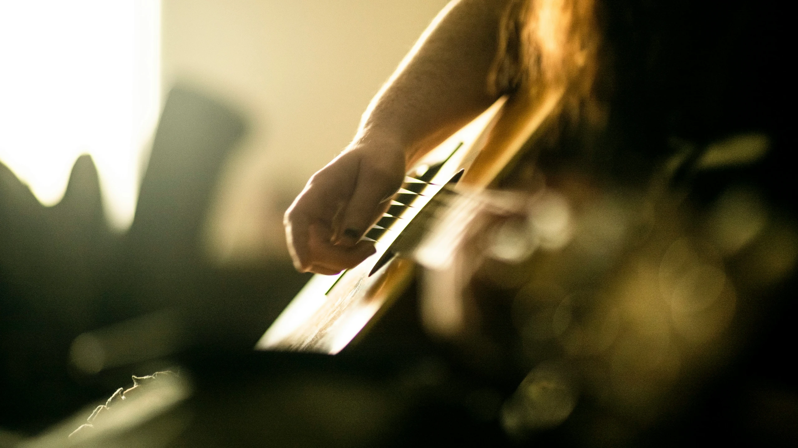 a person's hand on an electric guitar