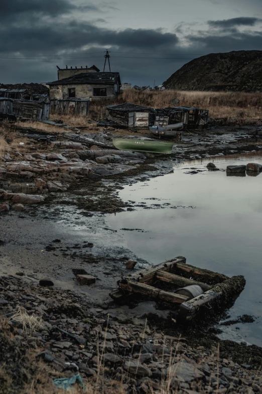 an old, run down fishing village sits on land next to water