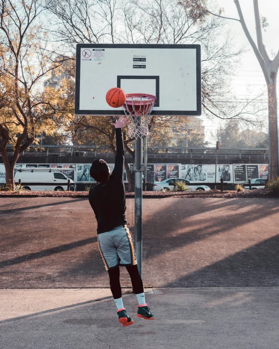 a man shooting a basketball over the rim