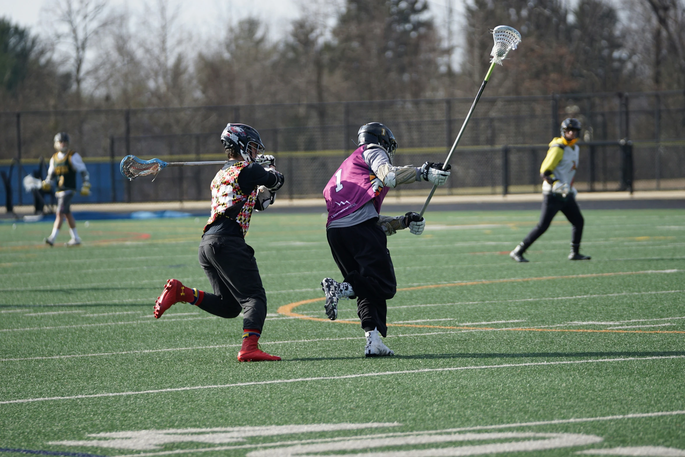 two women in goalie gear running on a field