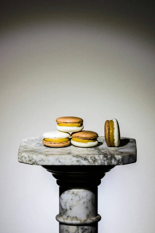 a marble display table topped with pastries