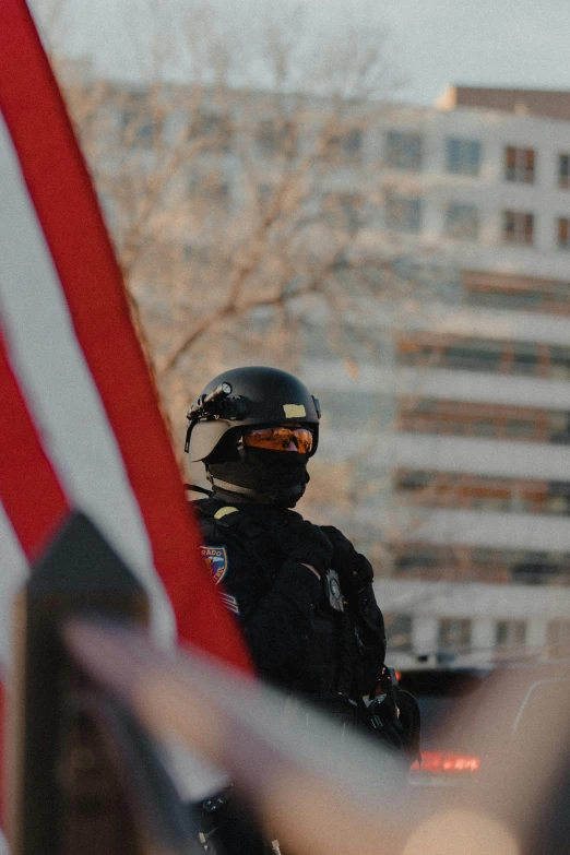 the motorcycle rider is holding an american flag