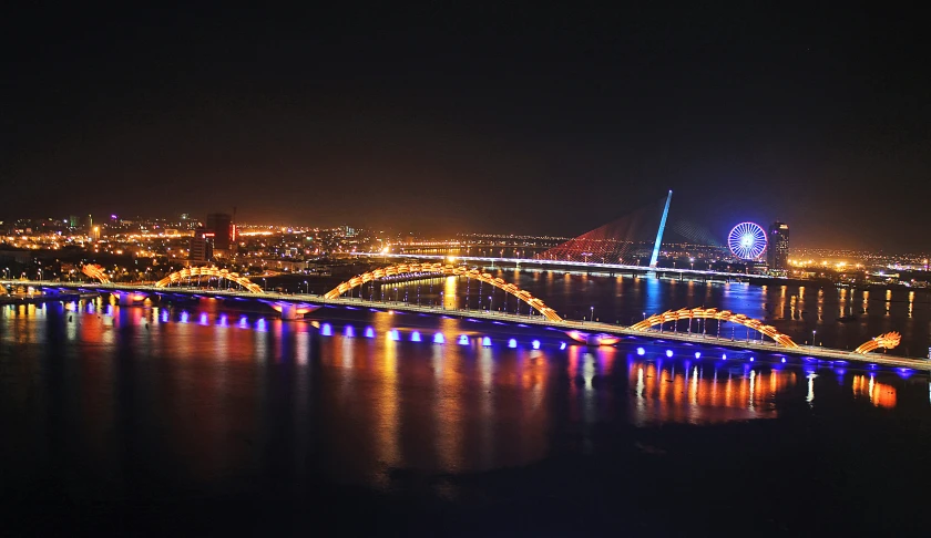 a night view of a bridge that is lit up in bright lights