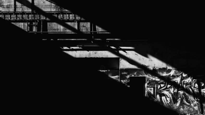 black and white pograph of some stairs, one with a person walking up it
