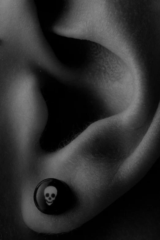 a skeleton ear piercing in black and white