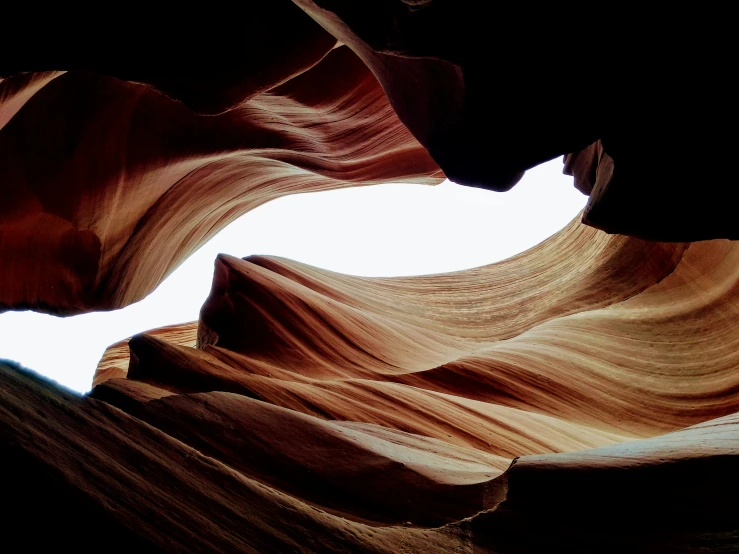 looking up at a canyon with a few clouds in the sky