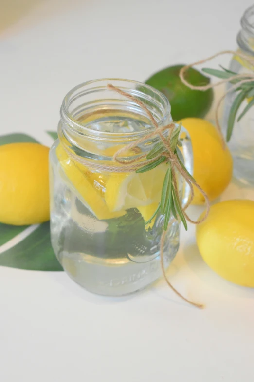 a glass jar filled with lemons and a small slice of lemon