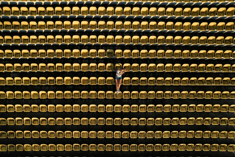 a man with a suitcase is walking down a stage full of seats