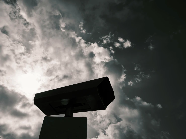 a street sign with cloudy sky background