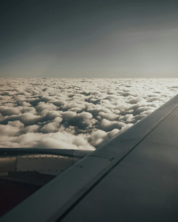 view of the wing from the window looking out on some clouds