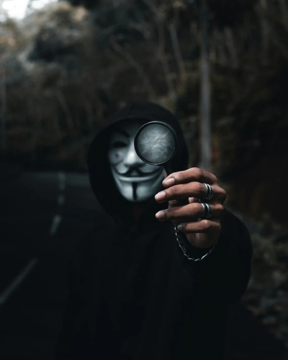 a person in a mask holding an object