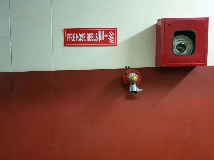 red and white walls with a red fire hydrant and a sign