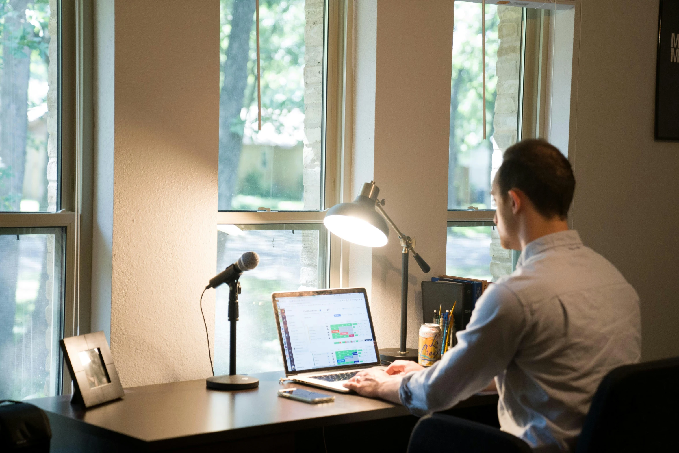 a man sitting at a desk working on his computer