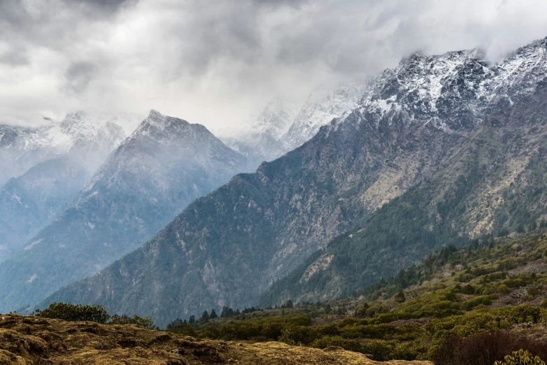 a view of the mountains in front of dark clouds