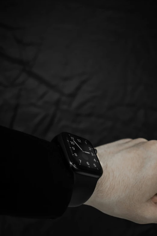 a man wearing an apple watch while sitting down