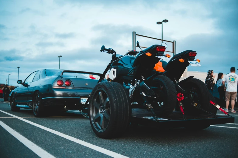 two motorcycle that are driving next to some cars