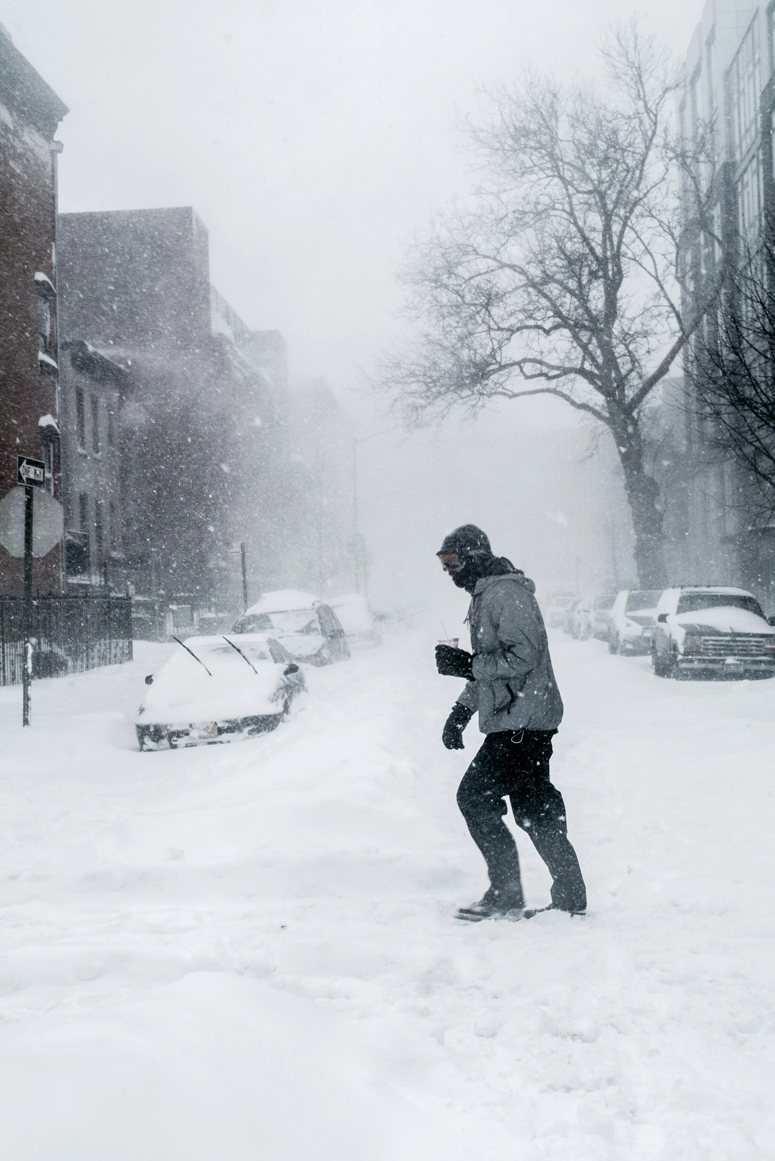 a man is walking through the snow on his snowboard