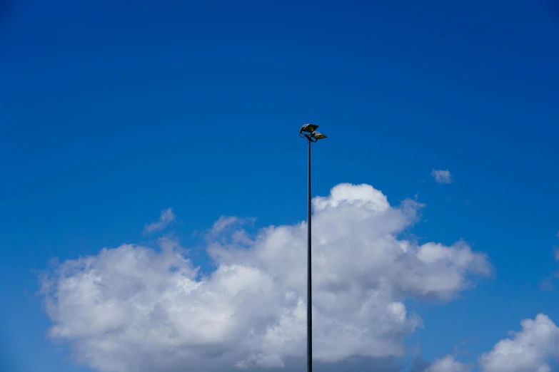 an airplane is flying over the clouds and the tower