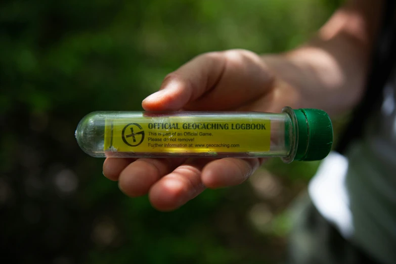 a close - up of the tip of an alcohol can held in the palm of someone's hand